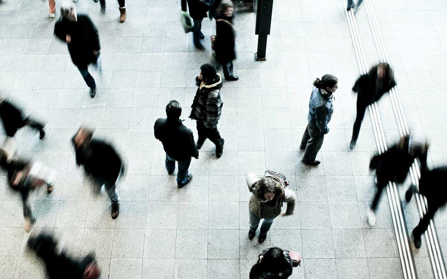 an aerial view of people walking outside in a city